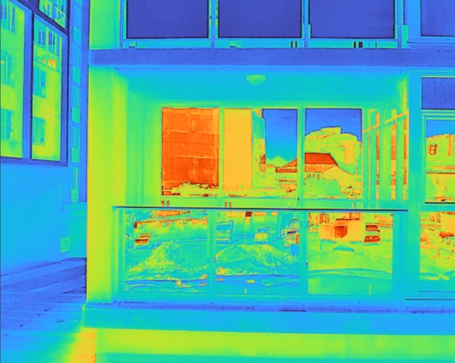 Close-up of exterior building wall showing a large area of stepped masonry cracks highlighted in red.